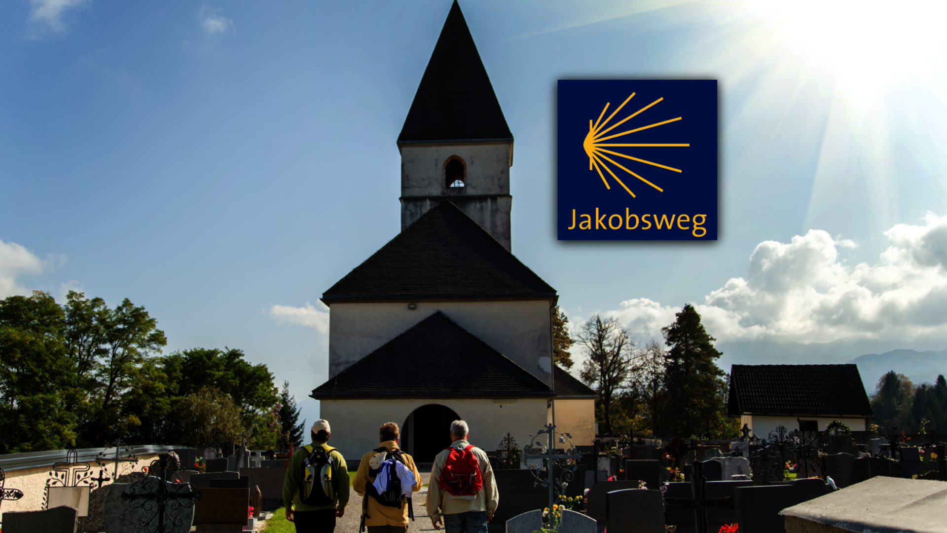 <p>Bild einer Kirche mit drei Pilgern und Logo des Jakobsweges.</p>